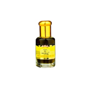 May include: A small, clear glass bottle of Attar Majmua perfume with a gold-colored cap. The bottle has a yellow label with black text that reads "Attar 96 Majmua" and "Nemat Enterprises Pvt. Ltd."
