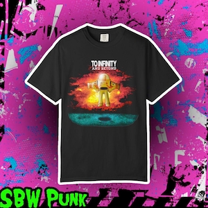 May include: A black short-sleeve t-shirt featuring a graphic of a space ranger character standing in front of a bright orange and yellow nebula. The text "TO INFINITY AND BEYOND" is printed in white above the character, with a dark blue lunar surface below.