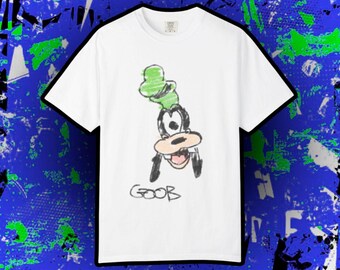 May include: White t-shirt featuring a hand-drawn illustration of Goofy with a green hat. The word "GOOB" is written in black below the character. The shirt has a classic crew neck and short sleeves.