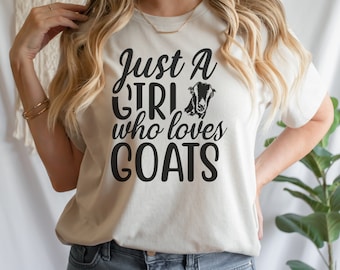 May include: A white t-shirt with the text "Just a girl who loves goats" in black lettering. A black silhouette of a goat's head is above the word "girl".