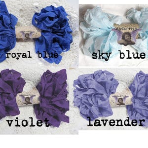 May include: Four bundles of fabric ribbon in royal blue, sky blue, violet, and lavender. Each bundle is tied with a decorative tag that reads "Wicked Pixy". The text "royal blue", "sky blue", "violet", and "lavender" are printed below each bundle.