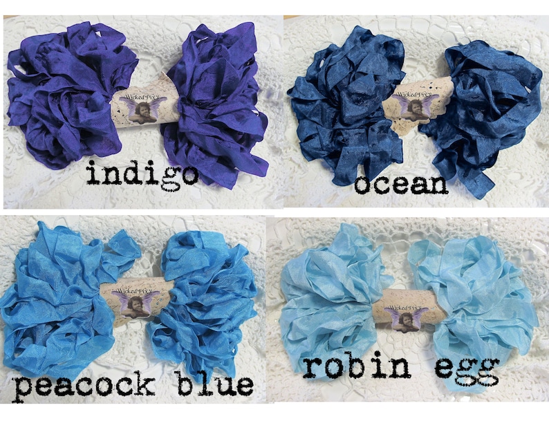 May include: Four bundles of fabric ribbon in indigo, ocean, peacock blue, and robin egg colors. Each bundle is tied with a label that reads "Wicked Pixie". The text "indigo", "ocean", "peacock blue", and "robin egg" are written below each bundle.