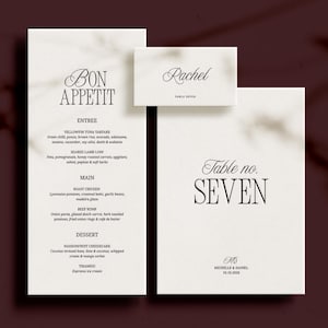 Op de afbeelding: Een elegante trouwbriefpapierset met een menu, een naambordje en een tafelnr. Het menu toont "Bon Appetit" en een lijst met gerechten. Het naambordje leest "Rachel", en het tafelnummer is "Zeven".