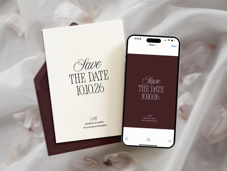 May include: Elegant wedding invitation suite featuring a cream-colored card with the text "Save the Date 10.10.26" in a stylish font, accompanied by a matching burgundy envelope. A smartphone displays the same design.