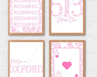 May include: Four framed prints with a white background and pink text and floral designs. The prints feature the words "Redhawks", the number "513" and "Oxford, Ohio", "Meet you in Oxford", and a playing card with the text "Lucky to be a Redhawk".