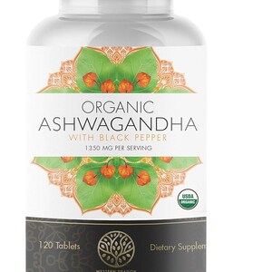 May include: A white bottle of dietary supplements labeled "Organic Ashwagandha with Black Pepper." The label features a green and orange floral design and the text "1350 MG PER SERVING." The bottle contains 120 tablets and is USDA Organic certified.