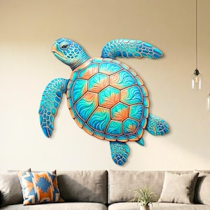 May include: A large, colorful wall art piece depicting a sea turtle. The turtle features a blue head and flippers, with a shell in shades of turquoise and orange. The artwork is mounted on a neutral-colored wall above a gray sofa.