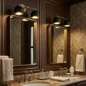 May include: A bathroom vanity with two mirrors, each framed in gold. Above each mirror are two black sconces with gold accents. The vanity features a marble countertop, gold fixtures, and decorative towels.