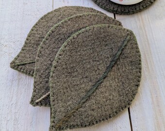 Porta-copos em formato de folha com veios verdes em degradê