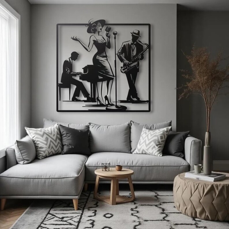 May include: A black metal wall art piece depicting a jazz band. The artwork features a singer, a pianist, and a saxophonist. The figures are set against a square frame, creating a silhouette effect. The art is mounted above a gray sectional sofa.