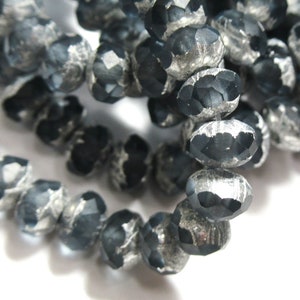 May include: A strand of dark gray faceted glass beads with a silver metallic finish.