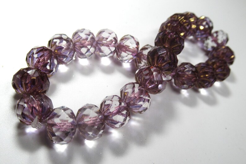 RESTOCKED Czech Glass 10mm x 7mm Faceted Crullers in Transparent Glass with Purple and Golden Bronze Shimmer Finishes 10 jewelry beads 25 Beads Strung