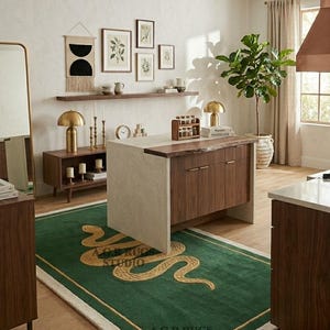 May include: A rectangular area rug featuring a deep green field with a gold-colored snake motif and a thin gold border. The rug has a cream-colored fringe edge and displays the text A.G.R RUGS STUDIO in two locations on the surface.