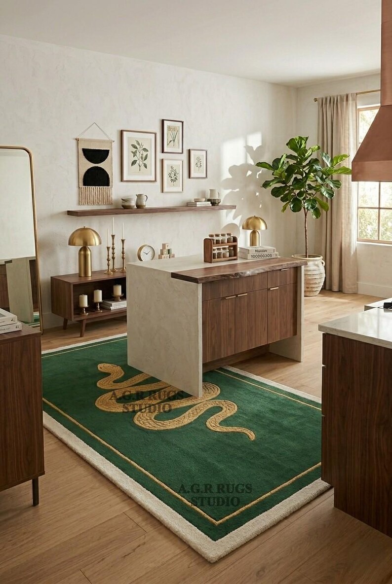May include: A rectangular area rug featuring a deep green field with a gold-colored snake motif and a thin gold border. The rug has a cream-colored fringe edge and displays the text A.G.R RUGS STUDIO in two locations on the surface.