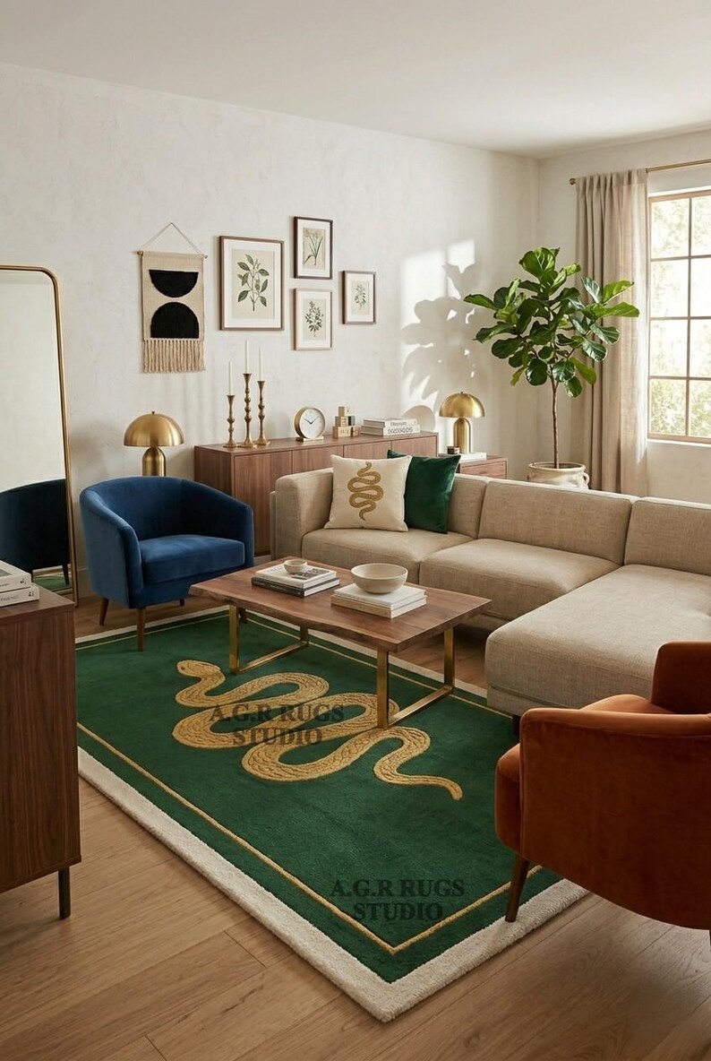 May include: A rectangular area rug featuring a deep green background with a large, gold-colored snake motif winding across the center. The rug has a thin gold border and a white fringe edge. The text A.G.R RUGS STUDIO is printed on the rug surface.