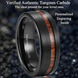 May include: A black tungsten carbide ring with a brushed finish and a central inlay of reddish-brown wood. The ring has the words "tungsten Carbide" engraved on the side. The image also includes the text "Verified Authentic Tungsten Carbide" and "Personalized Engraving Inside".