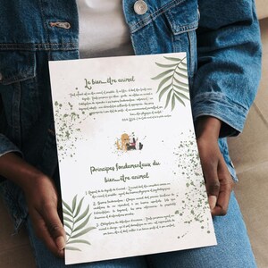 May include: A white paper with French text about animal welfare, held by a person wearing a denim jacket. The paper has green watercolor accents and illustrations. The title "Principes fondamentaux du bien-être animal" is visible.