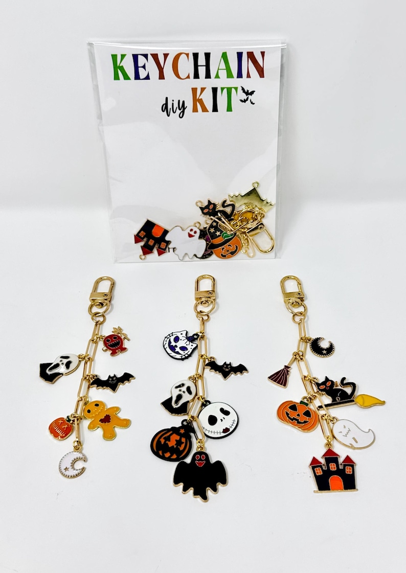 May include: Halloween-themed keychain DIY kit with gold-colored chains and charms. Charms include ghosts, bats, pumpkins, and a haunted house. The kit's packaging reads "KEYCHAIN diy KIT" in colorful letters.