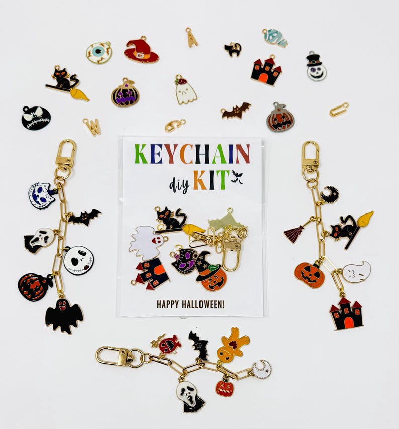 May include: A Halloween-themed keychain DIY kit with various charms, including pumpkins, ghosts, bats, and witch hats. The kit includes gold-colored keychains and a card that reads "KEYCHAIN DIY KIT" and "HAPPY HALLOWEEN!"