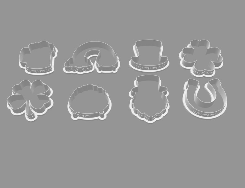 Peut inclure: Un ensemble d'emporte-pi&egrave;ces sur le th&egrave;me de la Saint-Patrick. L'ensemble comprend des formes telles qu'une chope de bi&egrave;re, un arc-en-ciel, un chapeau de leprechaun, un tr&egrave;fle &agrave; quatre feuilles, un pot d'or, un visage de leprechaun et un fer &agrave; cheval. Les emporte-pi&egrave;ces sont blancs sur fond gris.