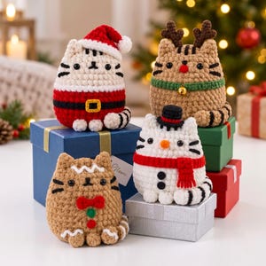 May include: Four crocheted cat figurines with holiday themes. One wears a Santa hat and suit, one has reindeer antlers and a bell collar, one is styled as a snowman with a top hat and scarf, and one resembles a gingerbread cookie with a red bow.