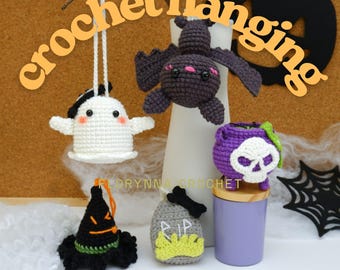 May include: Crochet Halloween decorations including a white ghost, a bat, a witch's hat, a tombstone, and a cauldron with a skull. The word "crochet hanging" is written in orange. The decorations are on a brown background.