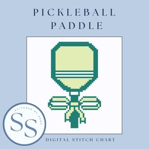 May include: Digital stitch chart with a pixelated pickleball paddle design in green and yellow. The text "PICKLEBALL PADDLE" is at the top, with "DIGITAL STITCH CHART" at the bottom. A circular logo with the letters "SS" is in the lower left corner.