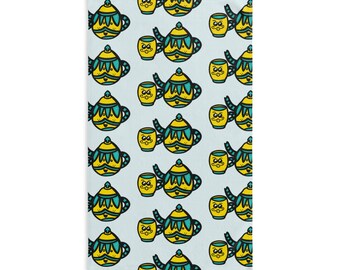 May include: A light blue rectangular object with a repeating pattern of yellow and teal teapots and teacups. The teapots have a decorative design, and the teacups have a smiling face. The pattern is set against a light blue background.