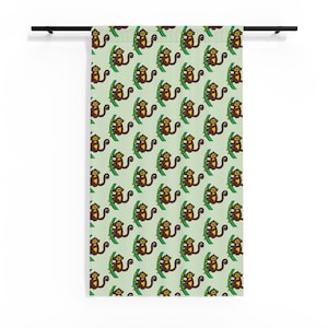 May include: A light green curtain featuring a repeating pattern of brown and yellow monkeys climbing green vines. The fabric is suspended from a black horizontal rod, displaying a consistent graphic design of small primates across the surface.