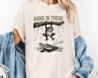 Comfort Colors® "Hang in There, It Gets Worse" Shirt | Funny Frog T-Shirt | Dark Humor Alligator Graphic Tee | Funny Sarcastic Shirt