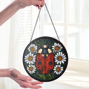 Botanical stained glass art suncatcher with ladybug centerpiece, round floral glass hanging for bright windows