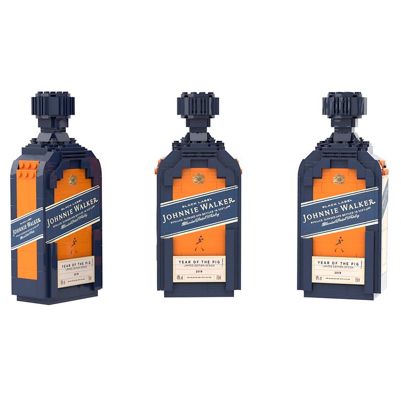 May include: Three Johnnie Walker Black Label bottles constructed from building blocks. The bottles are primarily navy blue and orange, with white and blue labels. The text "Johnnie Walker" and "Year of the Pig" are visible on the labels.