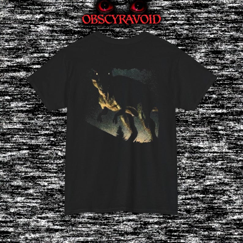 This analog horror–inspired T-shirt features a terrifying decayed dinosaur with human-like eyes and sharp teeth under the phrase “Something old is awake again.” The design combines VHS-style grain, eerie lighting, and vintage texture to create a haunting prehistoric horror vibe. Perfect for analog horror fans, dinosaur lovers, and retro-style collectors. Printed on high-quality fabric for lasting comfort and style.