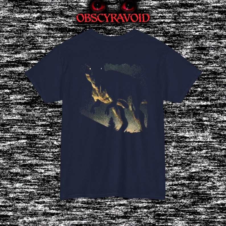 This analog horror–inspired T-shirt features a terrifying decayed dinosaur with human-like eyes and sharp teeth under the phrase “Something old is awake again.” The design combines VHS-style grain, eerie lighting, and vintage texture to create a haunting prehistoric horror vibe. Perfect for analog horror fans, dinosaur lovers, and retro-style collectors. Printed on high-quality fabric for lasting comfort and style.