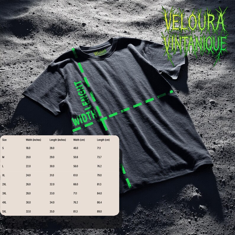 May include: Dark gray t-shirt with the text "VELOURA VINTANIQUE" in green, along with a size chart showing width and length in inches and centimeters. The shirt has a crew neck and short sleeves. The image is on a textured surface.