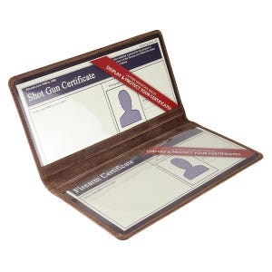 May include: Open brown leather certificate wallet displaying a Shot Gun Certificate and a Firearm Certificate. Red bands with the text "DISPLAY & PROTECT YOUR CERTIFICATES" are inserted in the wallet.