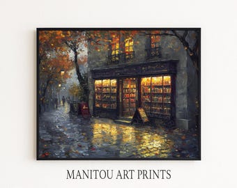 May include: An art print depicting a bookstore at night, with warm interior lighting. The exterior features a dark facade, wet cobblestone street, and autumn foliage. The print is framed in black, with the text "MANITOU ART PRINTS" at the bottom.