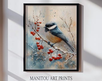 May include: A framed watercolour print depicting a small bird with a black head and blue wings perched on a snow-covered branch with red berries. The print has a soft, watercolour background and the text "MANITOU ART PRINTS" at the bottom.