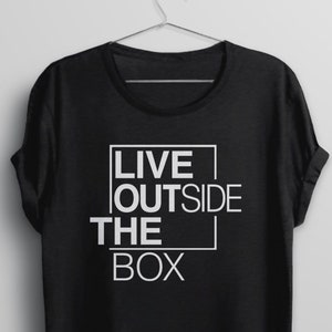 May include: Black t-shirt with white text that reads "LIVE OUTSIDE THE BOX" in a box.