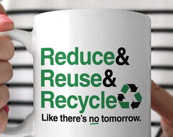 May include: White ceramic mug with a green and black design that says "Reduce & Reuse & Recycle Like there's no tomorrow."