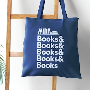 Books and Books Helvetica text with bookshelf graphic on a royal blue canvas tote bag