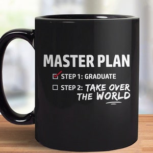 May include: Black coffee mug with white text that reads "MASTER PLAN" and a checklist with two items: "STEP 1: GRADUATE" with a checkmark and "STEP 2: TAKE OVER THE WORLD" with an empty box.