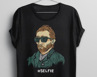 May include: Black t-shirt with a graphic of a man wearing sunglasses and a beard. The graphic is in a vintage style and the text '#SELFIE' is printed below the graphic.