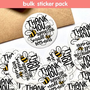 May include: A pack of round white stickers with black and yellow bee illustrations and the text "Thank You for Supporting Small Bees-ness".