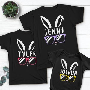 May include: Three black t-shirts with a bunny rabbit design wearing sunglasses. The shirts have the names "Jenny", "Tyler", and "Joshua" printed on them.