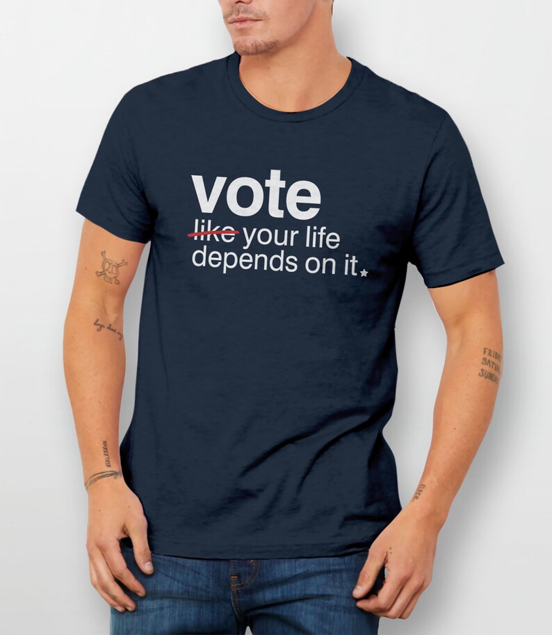 May include: A navy blue t-shirt with white text that reads "vote like your life depends on it*"