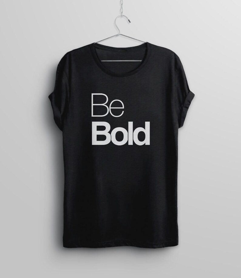 May include: Black t-shirt with white text that reads "Be Bold".