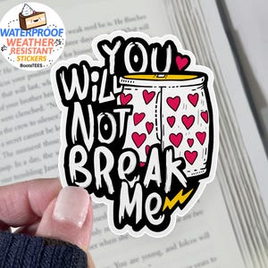May include: A white sticker with the text "YOU WILL NOT BREAK ME" in a bold, black font. The design includes a jar filled with red hearts and a yellow lightning bolt. The sticker is waterproof and weather-resistant.