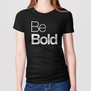 May include: A black t-shirt with the words "Be Bold" printed in white on the front.