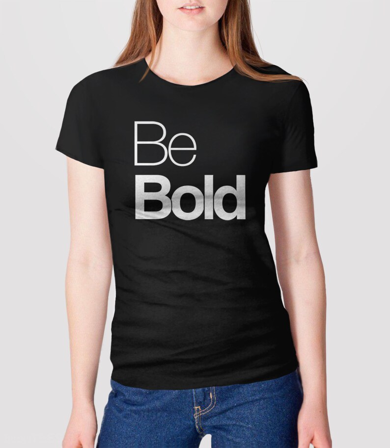 May include: A black t-shirt with the words "Be Bold" printed in white on the front.